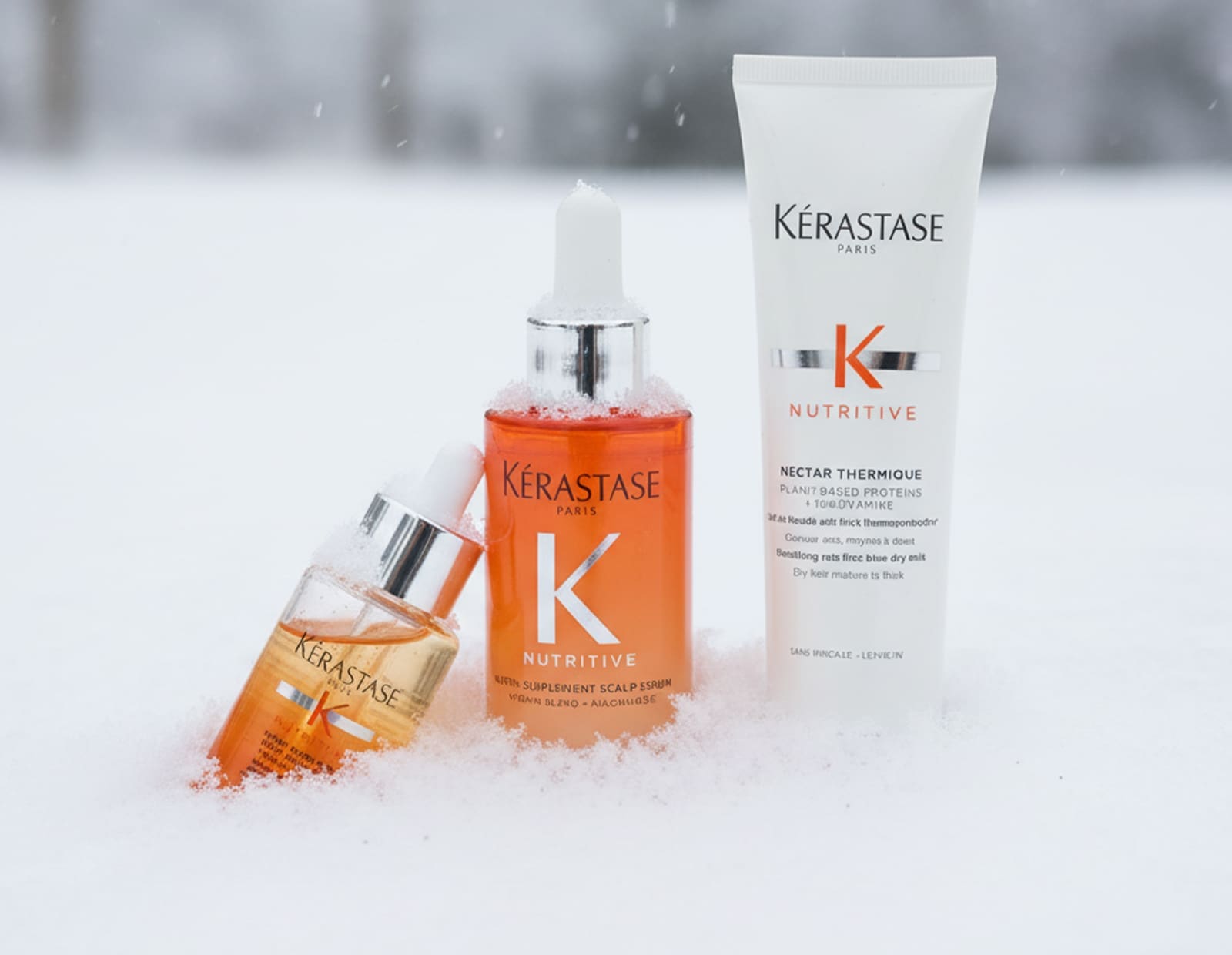 Image of Two glass bottles and plastic squeeze tube, Kerastase nutritive line.