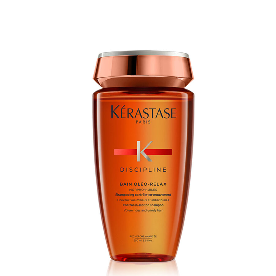 A bottle of kérastase discipline bain oléo-relax shampoo against a white background.