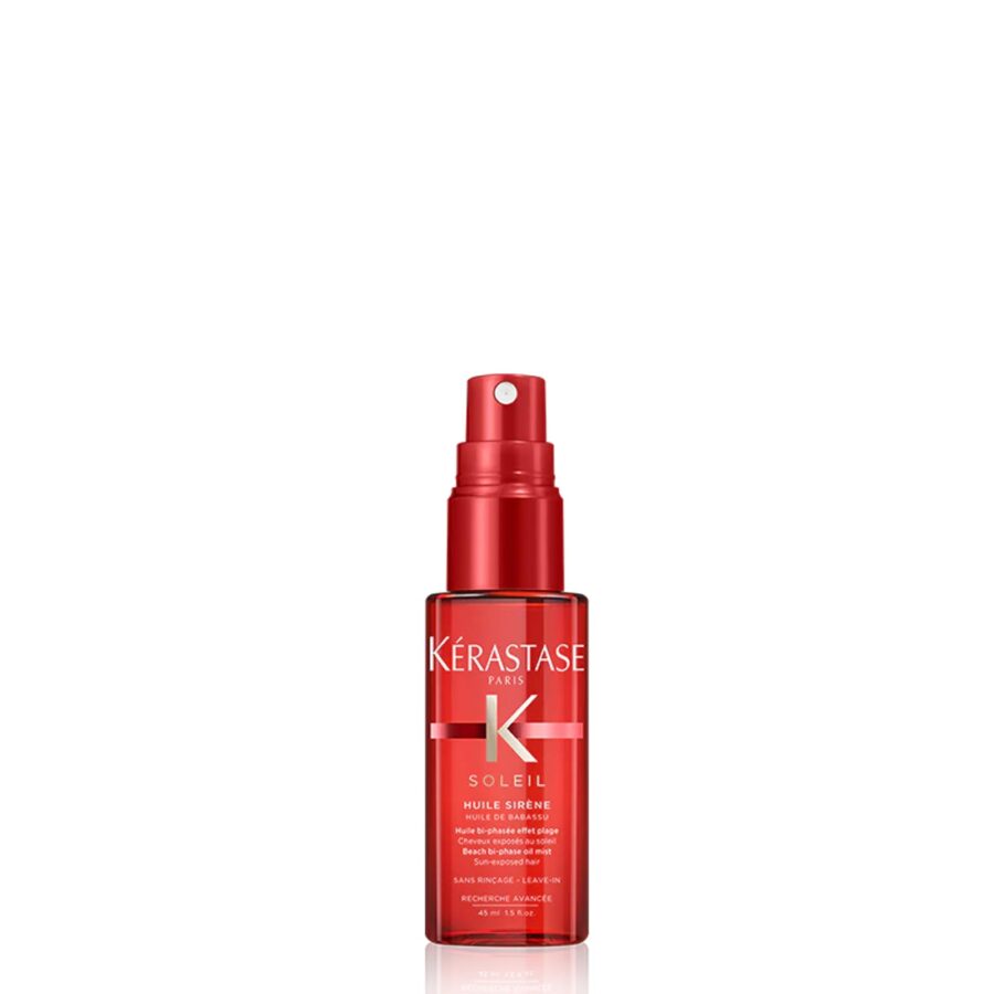 Red bottle of kérastase hair oil spray against a white background.