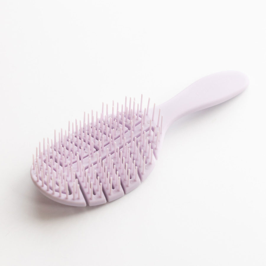 pommeshell the brand's lilac brush for detangling, and scalp stimulation